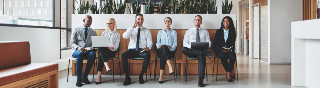 Diverse group of businesspeople waiting together in an office re Entreprises